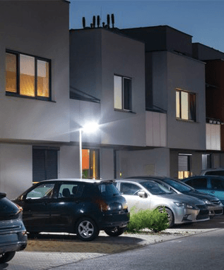 Residential complex parking area lit at night